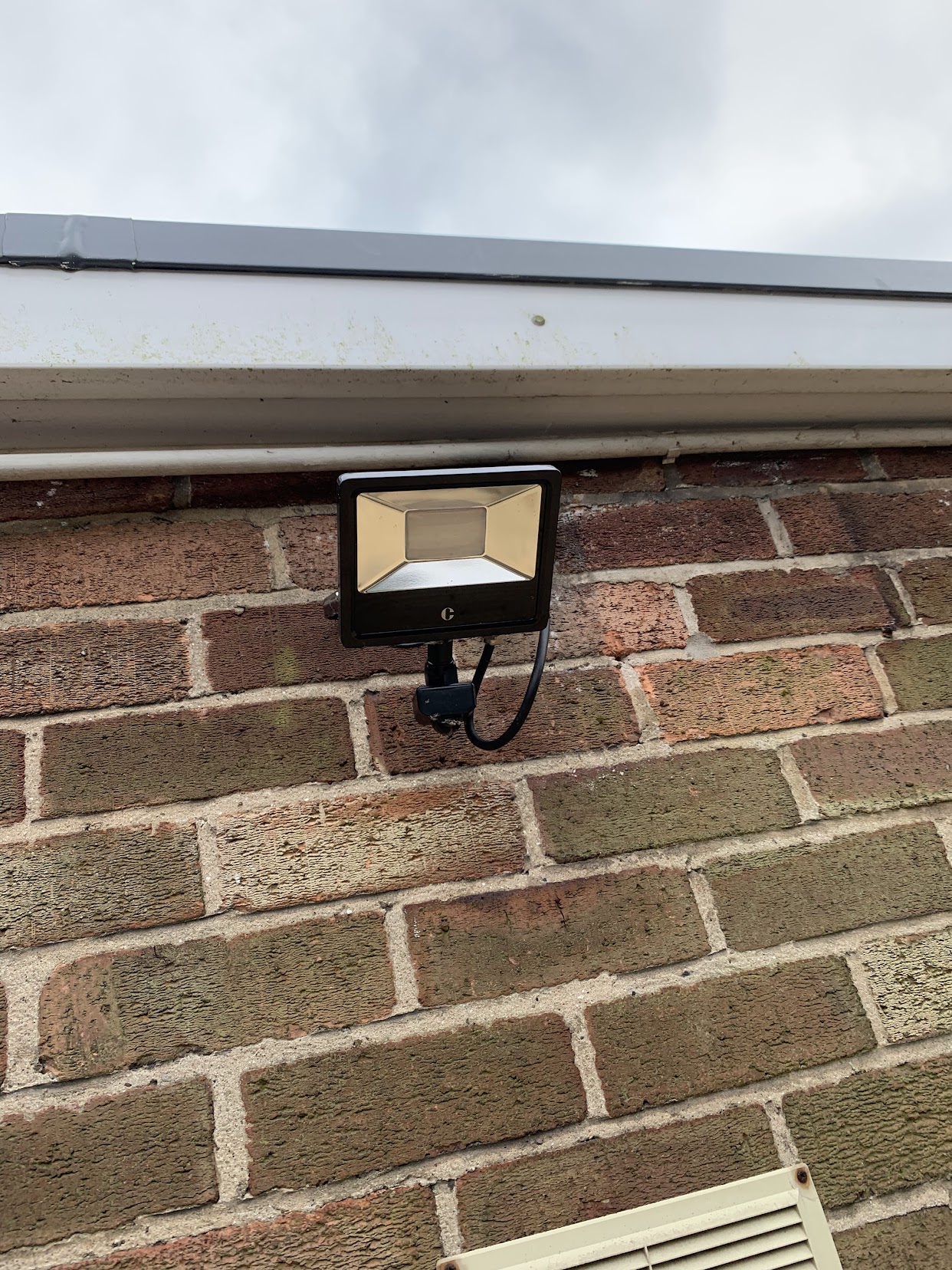 A neatly installed, professional-grade LED floodlight