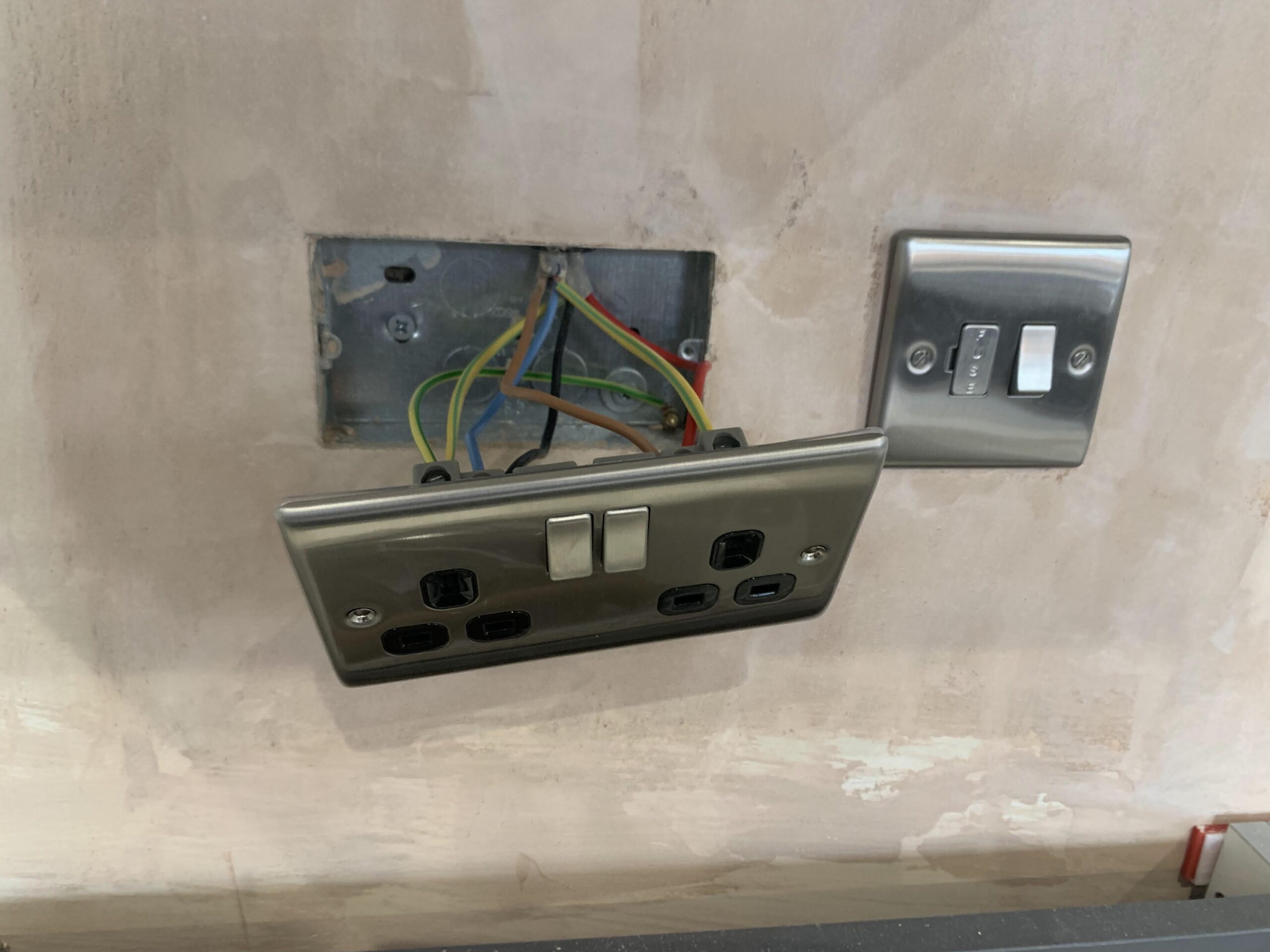 An old, yellowed plastic consumer unit, illustrating a potential recommendation for upgrade.